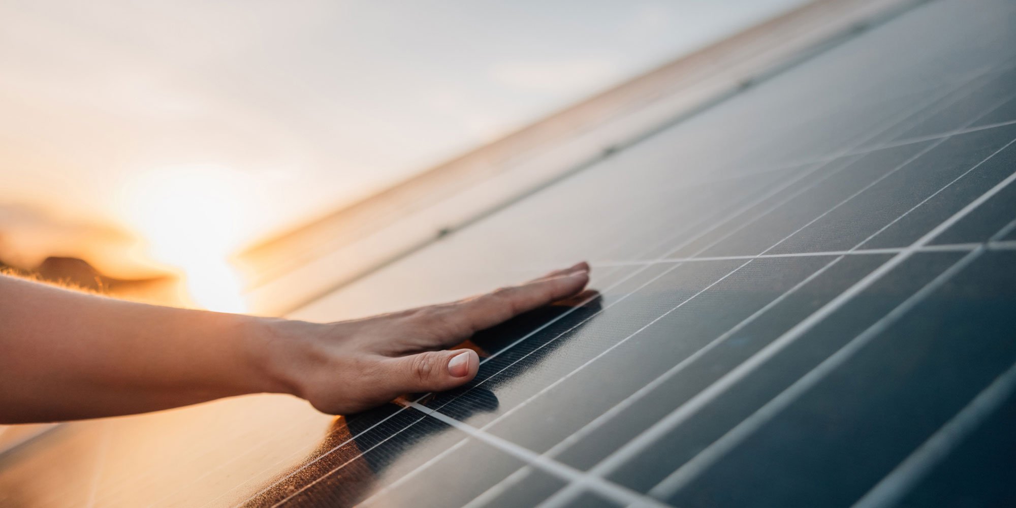 person touching solar panel