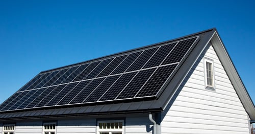 A house with a cost-effective rooftop solar panel array installation 
